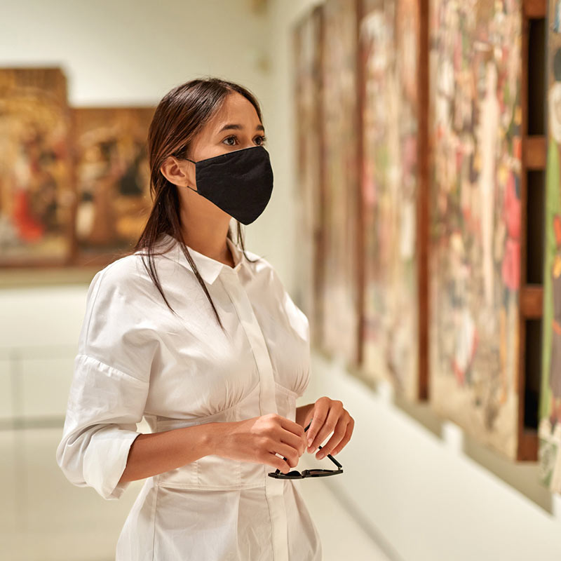 Masked woman at a museum